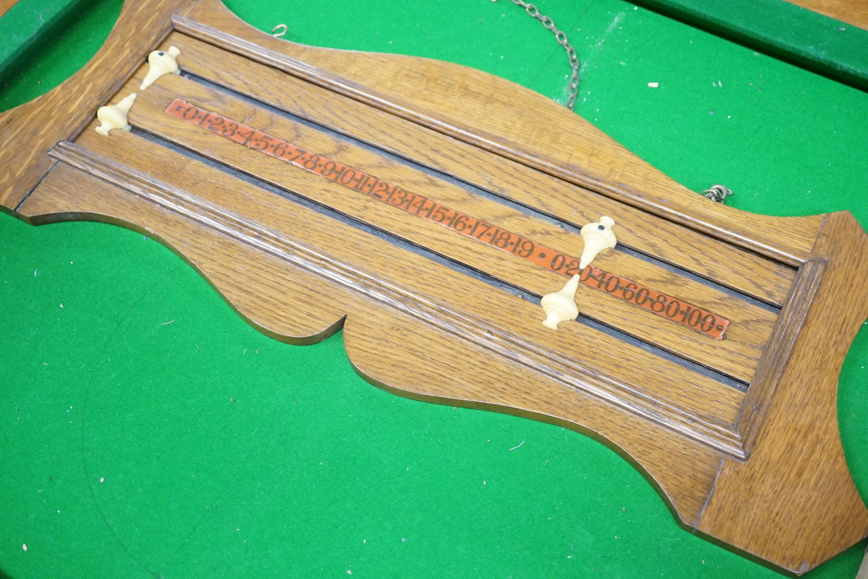 An early 20th century oak snooker / dining table, of rectangular serpentine form, with rise and fall action and full accessories, width 200cm depth 110cm height 74cm